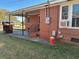 Brick house with a covered porch, featuring convenient steps and black railing at 1236 Fort Dr, Hanahan, SC 29410