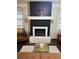 Chic fireplace with stone accents and a dark, modern mantel in a well-lit living space at 1236 Fort Dr, Hanahan, SC 29410