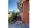 Side view of a brick home with black shutters, landscaping, and access steps at 1236 Fort Dr, Hanahan, SC 29410