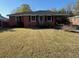 Well-maintained brick home with black shutters and tidy landscaping in a pleasant setting at 1236 Fort Dr, Hanahan, SC 29410
