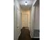 Hallway with hardwood floors and white walls featuring multiple doors and a ceiling light at 1236 Fort Dr, Hanahan, SC 29410