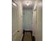 Hallway with white walls and doors, illuminated by a ceiling light fixture at 1236 Fort Dr, Hanahan, SC 29410