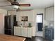 Kitchen with stainless steel refrigerator, white cabinets, butcher block counters, and access to a bathroom at 1236 Fort Dr, Hanahan, SC 29410