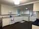 Well-lit kitchen featuring white cabinets, granite countertops, and modern appliances at 1236 Fort Dr, Hanahan, SC 29410