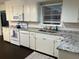Bright kitchen features white appliances, cabinets, and granite countertops, complemented by subway tile backsplash at 1236 Fort Dr, Hanahan, SC 29410