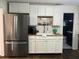 Well-lit kitchen featuring stainless steel refrigerator, white cabinets, and wood countertop at 1236 Fort Dr, Hanahan, SC 29410