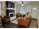 Bright and airy living room with a sleek fireplace, leather seating, and ample natural light at 1236 Fort Dr, Hanahan, SC 29410