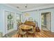 Cozy dining area featuring a round wooden table, decorative accents, and charming natural light from a nearby door at 1325 Telfair Way, Charleston, SC 29412