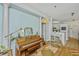 Dining area featuring a piano, round table, hardwood floors, and a view into the adjacent kitchen at 1325 Telfair Way, Charleston, SC 29412