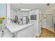 Bright kitchen featuring a breakfast bar with flowers, white cabinetry, and modern stainless steel appliances at 1325 Telfair Way, Charleston, SC 29412