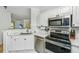 Updated kitchen featuring stainless steel appliances, white cabinets, and elegant countertops at 1325 Telfair Way, Charleston, SC 29412
