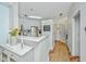 Bright kitchen featuring a breakfast bar with flowers, white cabinetry, and modern stainless steel appliances at 1325 Telfair Way, Charleston, SC 29412