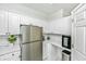 Well-lit kitchen featuring stainless steel appliances, modern white cabinets, and stylish backsplash at 1325 Telfair Way, Charleston, SC 29412