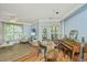 Inviting living room with hardwood floors, ceiling fan, television, and stylish dining area featuring a piano at 1325 Telfair Way, Charleston, SC 29412