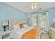 Comfortable main bedroom features a textured headboard, ceiling fan, and large window at 1325 Telfair Way, Charleston, SC 29412