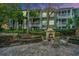 Charming outdoor fireplace and seating area, perfect for relaxing and entertaining al fresco, with building in background at 1325 Telfair Way, Charleston, SC 29412