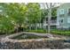 Scenic community pond with a lovely stone border surrounded by lush, mature landscaping at 1325 Telfair Way, Charleston, SC 29412