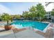 Refreshing community pool featuring well-maintained landscaping, lounge chairs, and tables with umbrellas at 1325 Telfair Way, Charleston, SC 29412