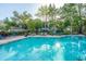 Relaxing community pool featuring seating and beautifully manicured landscaping and trees at 1325 Telfair Way, Charleston, SC 29412