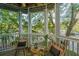 Comfortable screened porch features outdoor seating with lush greenery at 1325 Telfair Way, Charleston, SC 29412