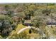 An aerial view of a home surrounded by lush trees, featuring a circular driveway and well-manicured lawn at 1515 Devons St, Charleston, SC 29412