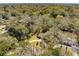 An aerial view of a home surrounded by lush trees, featuring a circular driveway and well-manicured lawn at 1515 Devons St, Charleston, SC 29412