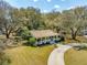 An aerial view showcasing the property, its expansive yard, and mature trees surrounding the home at 1515 Devons St, Charleston, SC 29412