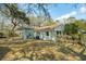 A backyard featuring a wooden deck, grassy area, and the home's exterior, perfect for outdoor entertaining at 1515 Devons St, Charleston, SC 29412