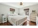 Sun-filled bedroom with warm wood floors, neutral walls, and two windows illuminating the interior at 1515 Devons St, Charleston, SC 29412
