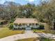 Charming single story home featuring a wide porch, well-maintained lawn, and mature trees at 1515 Devons St, Charleston, SC 29412