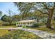 Quaint home featuring a covered front porch, lush landscaping, and a winding driveway at 1515 Devons St, Charleston, SC 29412