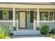 Inviting front porch with decorative plants, dark shutters and the home's address at 1515 Devons St, Charleston, SC 29412