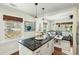 Open kitchen with dark countertop island flowing into the living room at 1515 Devons St, Charleston, SC 29412