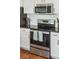 The kitchen range features a stainless steel oven and a microwave and white cabinets above at 1515 Devons St, Charleston, SC 29412