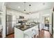 Modern kitchen with stainless steel appliances, white cabinets, and a dark countertop island with seating at 1515 Devons St, Charleston, SC 29412