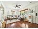 Bright living room features a comfortable gray couch, wood floors, and natural light from the windows at 1515 Devons St, Charleston, SC 29412