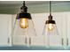 Close-up view of two pendant lights with glass shades, adding a stylish touch to the kitchen at 1515 Devons St, Charleston, SC 29412