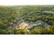 An aerial view of new home construction surrounded by lush trees and a tranquil pond at 182 E Pinckney St, Lincolnville, SC 29485