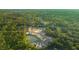 Aerial view of a residential construction site with pond, showcasing development within green landscape at 182 E Pinckney St, Lincolnville, SC 29485