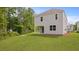 Backyard view of the home surrounded by lush greenery at 182 E Pinckney St, Lincolnville, SC 29485