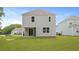 Backyard view of the house with a patio at 182 E Pinckney St, Lincolnville, SC 29485