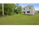 Wide shot of the large grass backyard at 182 E Pinckney St, Lincolnville, SC 29485