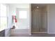 This bathroom features a separate shower with glass door and a soaking tub underneath a window at 182 E Pinckney St, Lincolnville, SC 29485