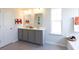 This bathroom features a double sink vanity, nautical decor, and a separate soaking tub at 182 E Pinckney St, Lincolnville, SC 29485