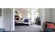 This bedroom features neutral walls, carpeted floors and sitting area by a window with natural light at 182 E Pinckney St, Lincolnville, SC 29485