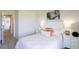 Bright bedroom features neutral walls, gray carpet, a comfortable bed with throw pillows, and a horse art piece at 182 E Pinckney St, Lincolnville, SC 29485