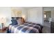 Cozy bedroom with a plaid comforter, world map decor, and a window allowing natural light to illuminate the room at 182 E Pinckney St, Lincolnville, SC 29485