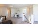 Bright bonus room with neutral carpet, white walls, and ladder access to the attic at 182 E Pinckney St, Lincolnville, SC 29485