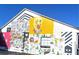 Building with colorful mural featuring artwork, an illuminated lightbulb, and playful imagery at 182 E Pinckney St, Lincolnville, SC 29485