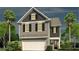 Charming two-story home featuring symmetrical window placement and an attached white two-car garage at 182 E Pinckney St, Lincolnville, SC 29485